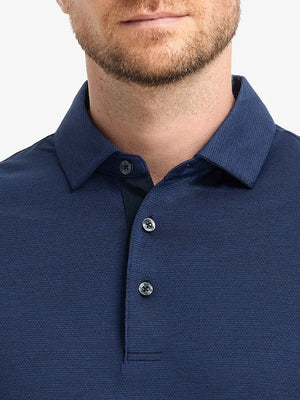 Model front view from nose to chest in DARK BLUE HEATHER Ventilated Heather Jacquard Polo