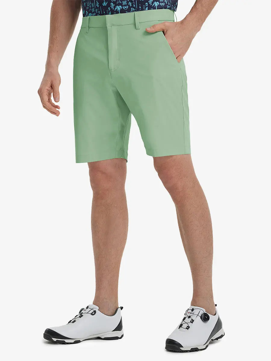 Front view of model’s lower body with hands in pockets, wearing Player Fit Versatile Solid Shorts 9 Inch – BERYL GREEN