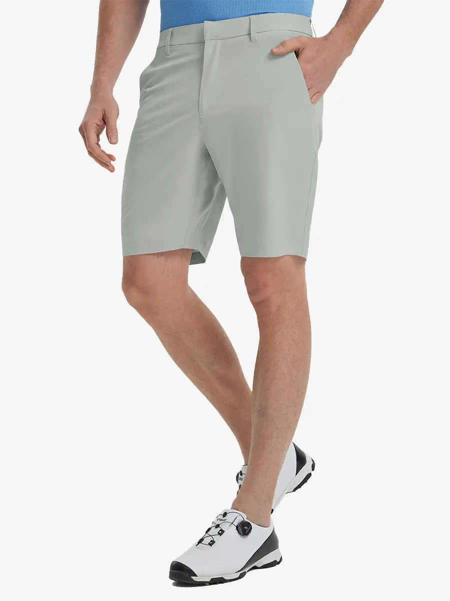 Front view of model’s lower body with hands in pockets, wearing Player Fit Versatile Solid Shorts 9 Inch – NEUTRAL GREY