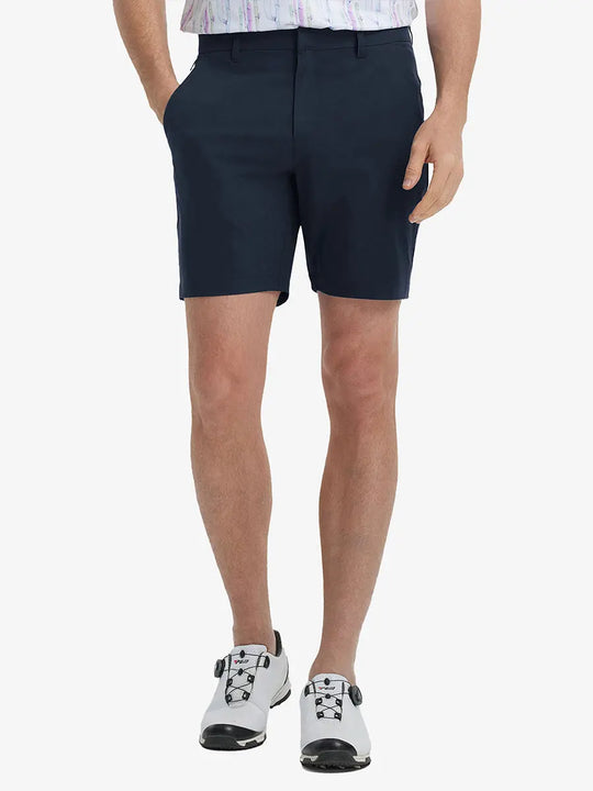 Front view of model’s lower body with hands in pockets, wearing Player Fit Versatile Solid Shorts 7 Inch – NAVY