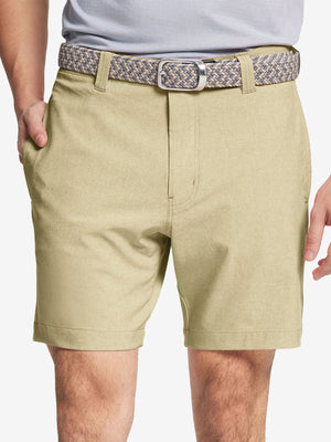 Front view of youth wearing khaki Heather Performance Golf Shorts, showing fit and style