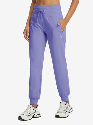 Model wearing women's stretch fleece lined water resistant joggers in lavender, showcasing the front lower body view.