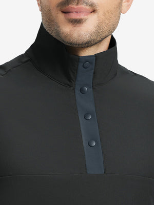 Close-up from nose to chest, highlighting buttoned collar and textured fabric of the black pullover.