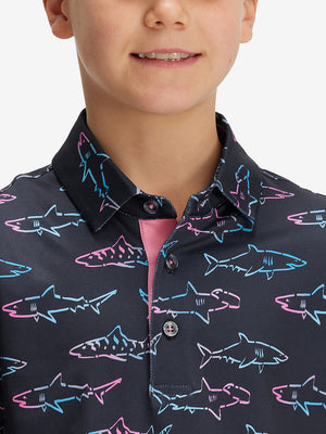 Close-up: nose to chest in ombre shark performance print boys golf polo