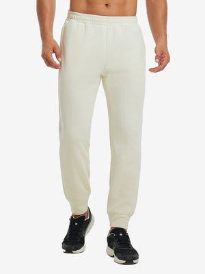 Front lower body view of model wearing soft sweatpants with 4 zipper pockets in beige