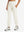 Model wearing women's stretch fleece lined water resistant joggers in beige, showcasing the front lower body view.