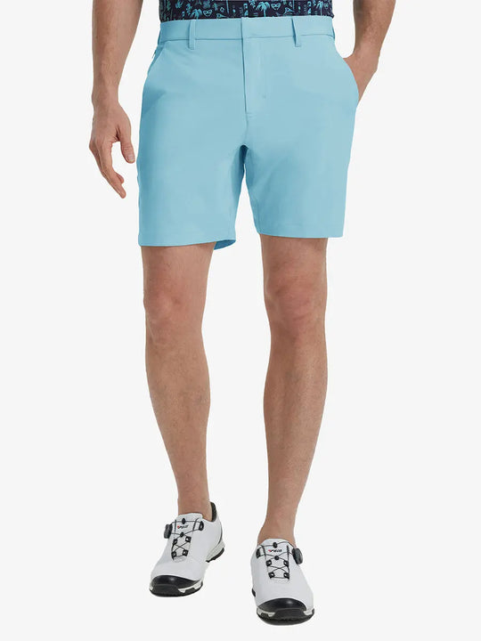 Front view of model’s lower body with hands in pockets, wearing Player Fit Versatile Solid Shorts 7 Inch – LIGHT BLUE