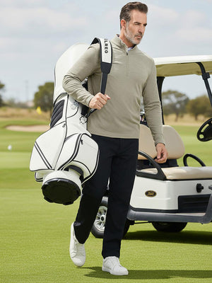 Texture heather fleece lined 1/4 zip pullover, model in dust beige carrying a golf bag full body view