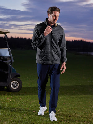 Model holding jacket collar on course, golf fleece winter puffer jackets with bold black look