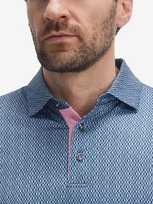 Close-up of lower face and upper shirt in Performance quick dry print golf polos, light blue navy circles detail
