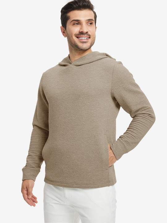 Model front upper body, one hand in pocket, wearing texture solid hoodies pullover, light brown heather.