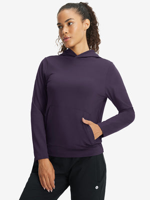 Model with one hand in side pocket wearing women's lightweight hoodies pullover in dark purple.