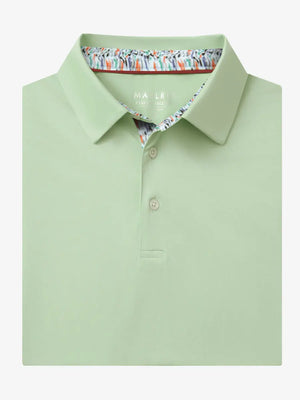 Folded Canary Green Everyday Classic Solid Polo neatly laid out for display