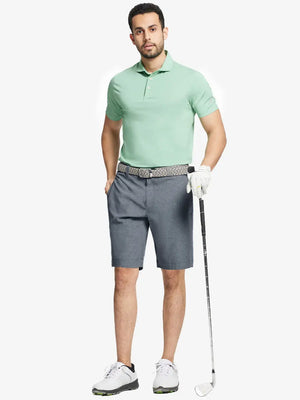 Full body front view of model wearing NAVY 9 Inch Heather Performance Golf Shorts, holding a golf club