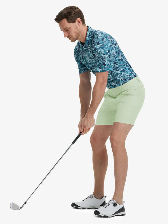 Full-body front shot of model holding golf club, wearing Player Fit Versatile Solid Shorts 7 Inch – LIGHT GREEN