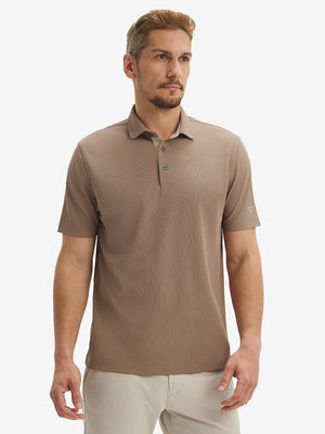 Front half-body shot of model wearing the light brown ventilated pique performance polo for a casual sporty look