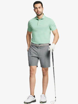 Full body front view of model wearing LIGHT GREY 7 Inch Heather Performance Golf Shorts, holding a golf club