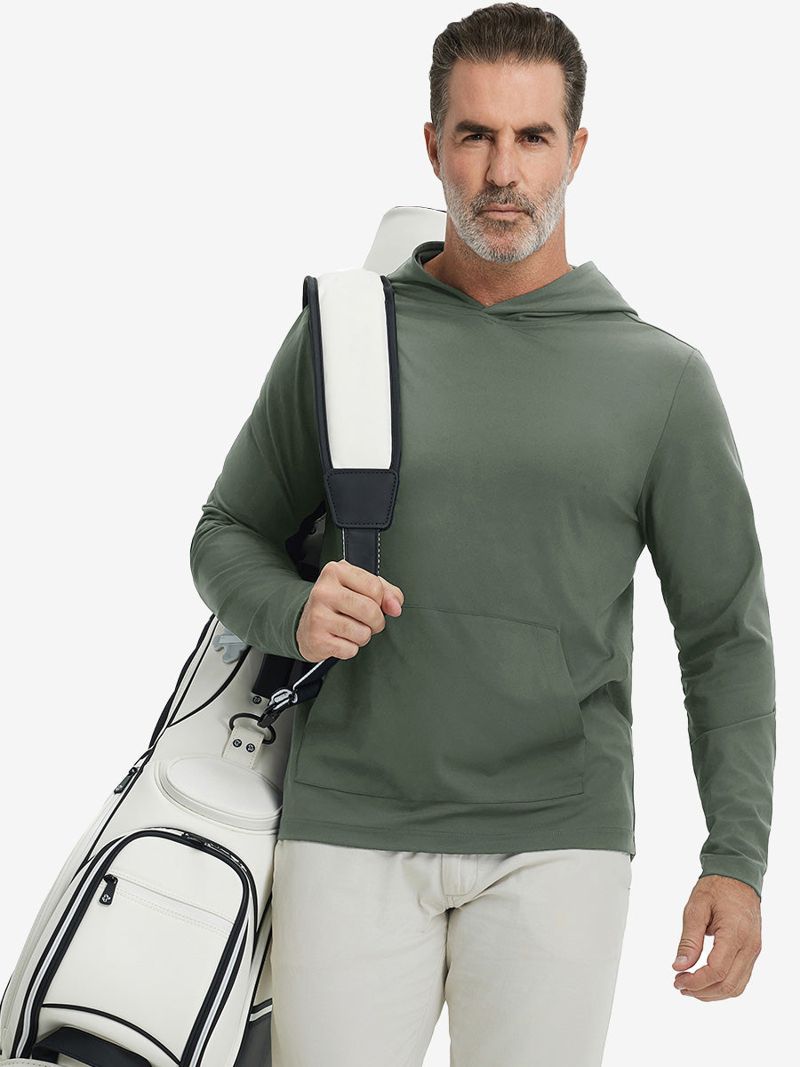 Model carrying golf bag, styled in olive green dry fit stretchy sweatshirts hoodie, modern athletic look.