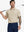 Half-body front view of model holding golf club wearing LIGHT KHAKI HEATHER Premium Stretch Heather Polo.
