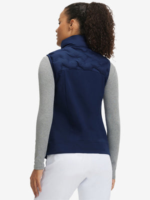 Back view of model in women's lightweight slim-fit puffer vest, showing shape and navy tone
