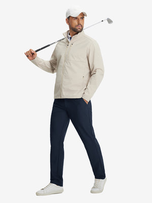 Model holding a golf club, wearing lightweight flat front casual trousers in navy, full-body view.