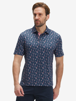 Front half-body shot of model wearing the navy sailboat 4 way stretch print collared polo shirt for a casual sporty look