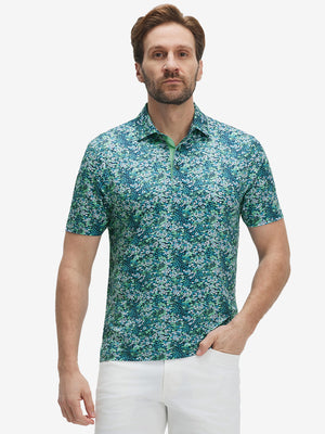 Male model front upper body wearing Performance quick dry print golf polos, sleek navy green floral look