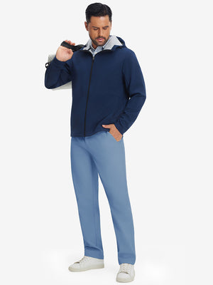 Full-body shot of model holding a golf bag while wearing misty blue thermal water repellent fleece dress pants
