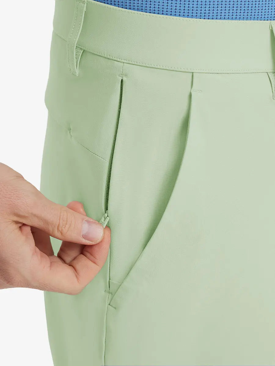 Close-up of right front pocket with zipper being opened on Player Fit Versatile Solid Shorts 7 Inch – LIGHT GREEN