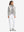 Model holding golf club full body, women's lightweight slim-fit puffer vest styled in sporty oyster grey