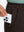 Close-up detail showing phone being placed in the pocket of coffee brown thermal water repellent fleece dress pants