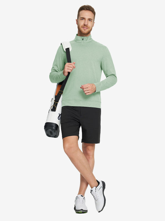 Full-body view of model carrying golf bag in quarter zip melange pullover beryl green melange.