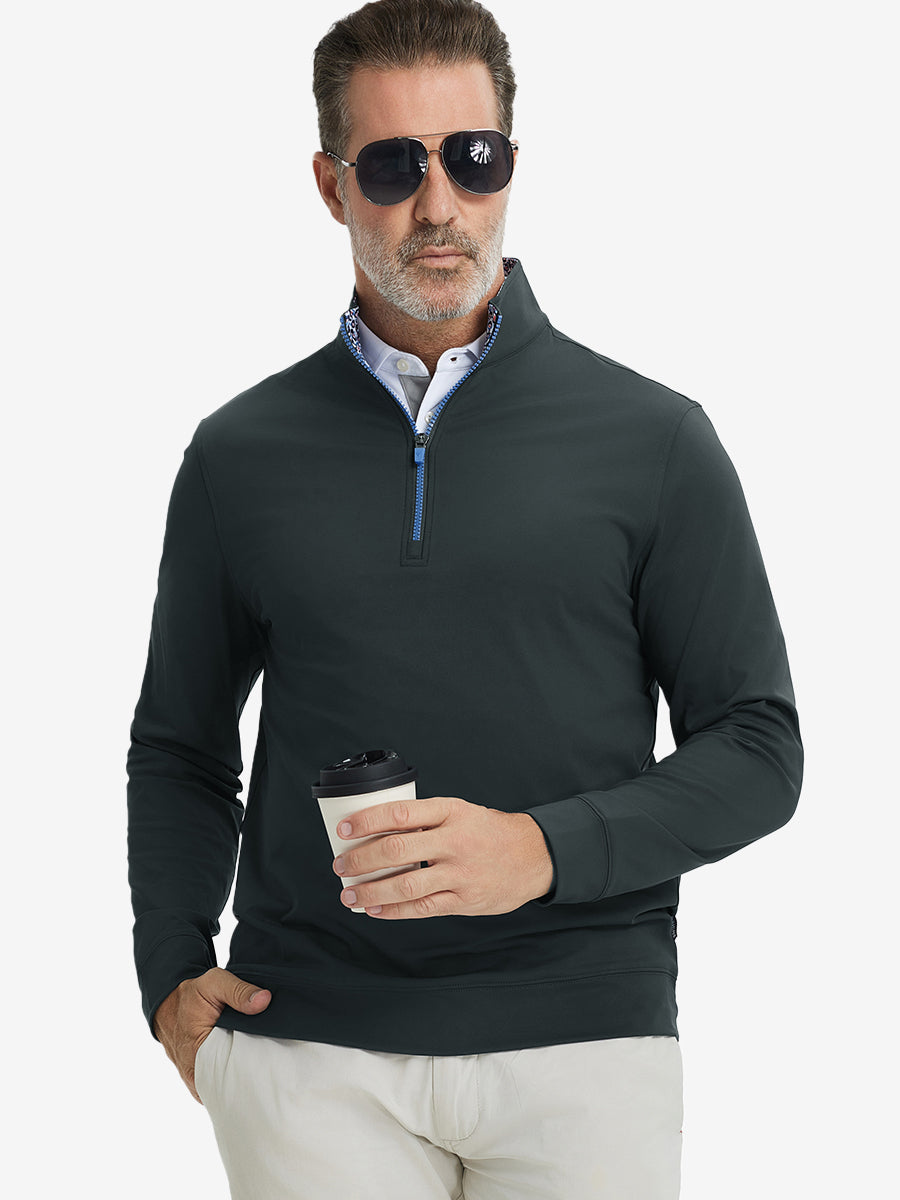 Front upper body view of model wearing lightweight golf quarter zip pullover in dark grey, relaxed fit.