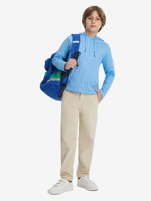 A full-body shot of a model wearing a youth full print stylish hoodie pullover in bluejay navy dogs.