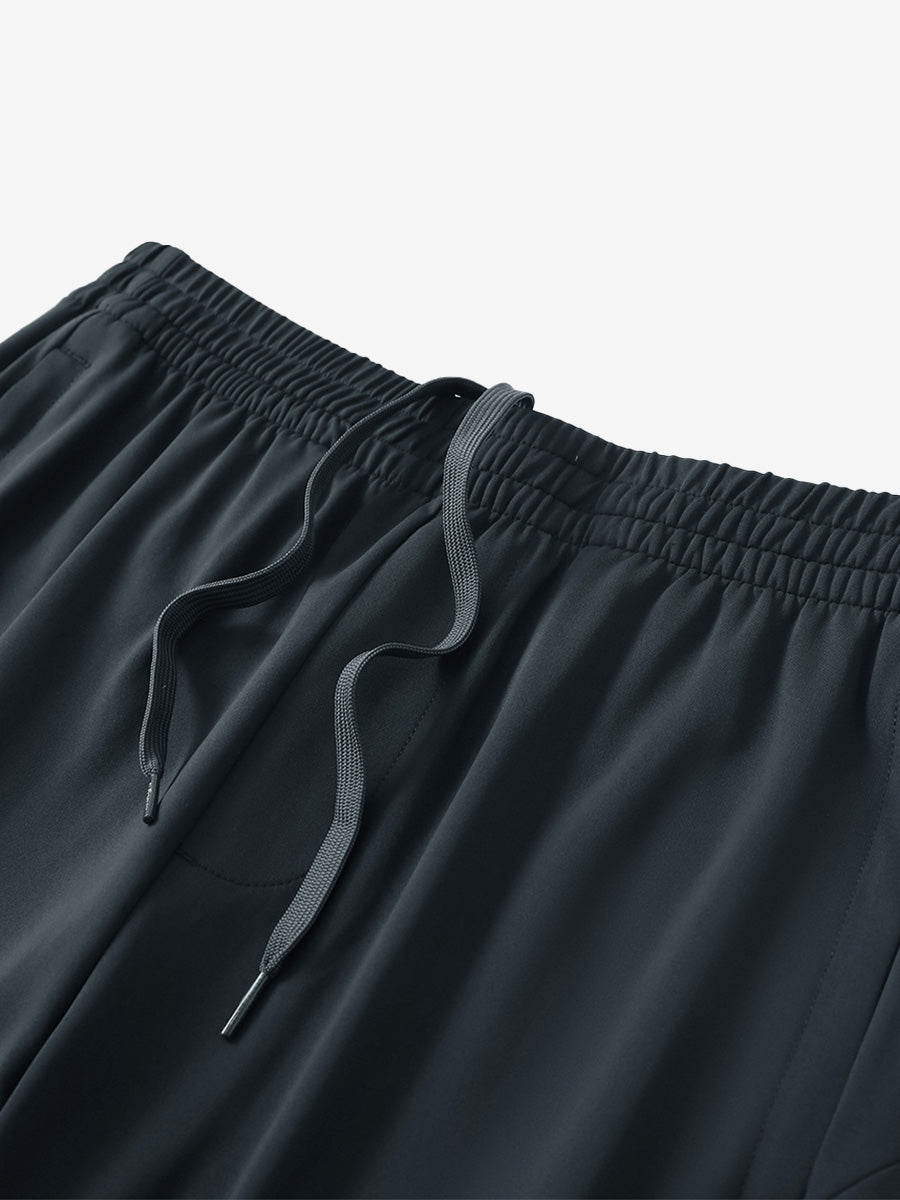 Angled view of lightweight women's stretchy joggers sweatpants waistband displayed in dark grey.