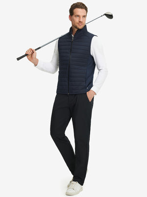 Model wearing Lightweight Water Resistant Puffer Vest in navy, holding golf club
