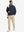 Model carrying golf bag in casual windproof bomber jacket, sporty look in navy