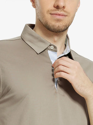 Male model wearing the Dark Khaki Everyday Classic Solid Polo, front view from nose to chest