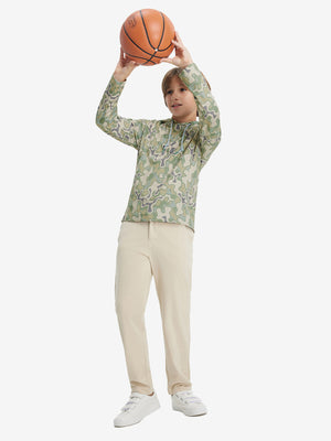 Model playing basketball, wearing beryl green camo flower youth full print stylish hoodies pullover in full-body view.