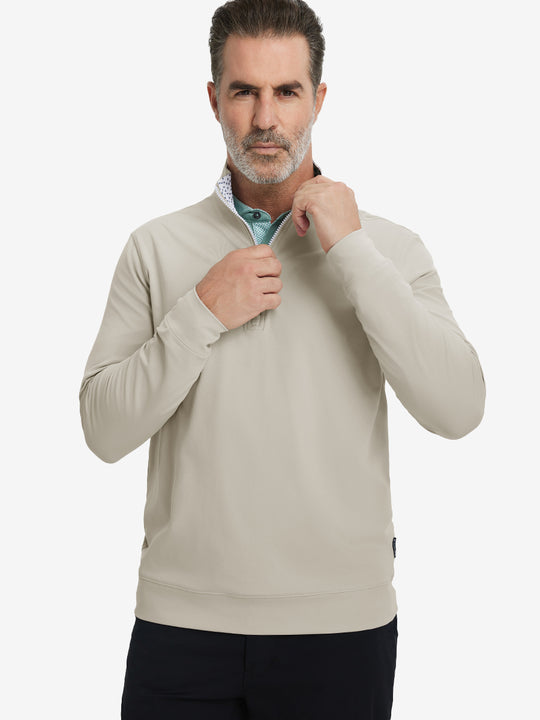 Front upper body view of model wearing lightweight golf quarter zip pullover in khaki light, relaxed fit.