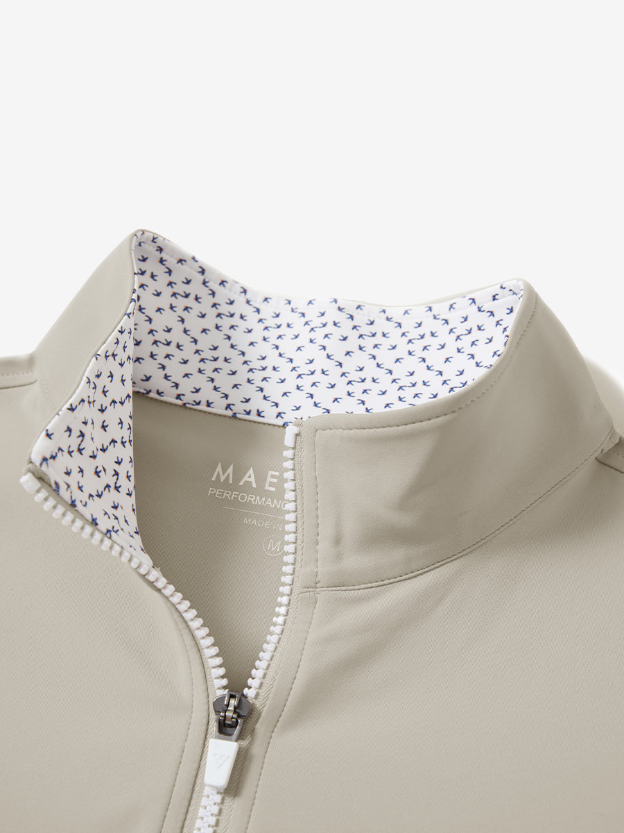 Collar zipper and inner neck pattern detail of the lightweight golf quarter zip pullover in khaki light.