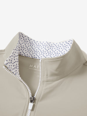 Zipper and inner pattern detail of the print collar quarter zip golf vest in khaki light, highlighting design.