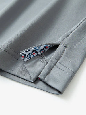 Close-up of side slit hem detail on LIGHT GREY Long Sleeve Solid Jersey Polo