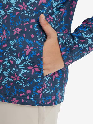 Model with both hands in pockets wearing youth full print stylish hoodies pullover in navy colorful flower.