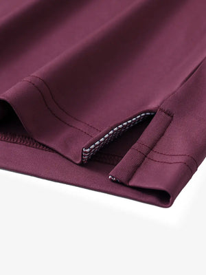 Close-up of side slit hem detail on BORDEAUX RED Long Sleeve Solid Jersey Polo