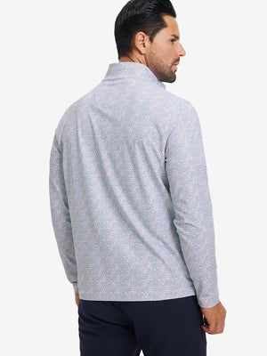 Back upper body angle of the colorful hexagon full print quarter zip pullover, model turns head slightly.