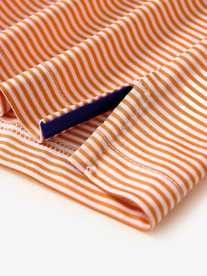 Detailed view of side hem slit on Cooling Stripe Golf Shirt in ORANGE STRIPE, showing comfort and design