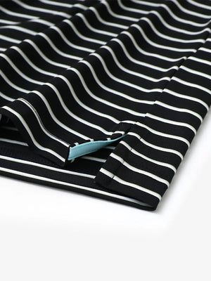 Hem slit detail of BLACK/WHITE STRIPE Youth Performance Golf Polo highlighting stitching and finish.
