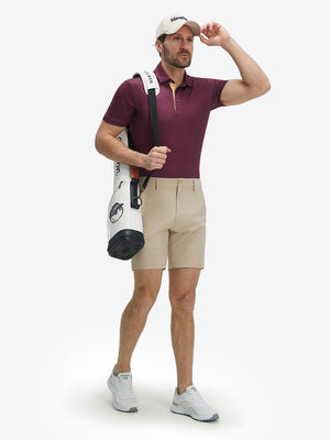 Full-body front view of model wearing the burgundy geometric 4 way stretch print collared polo shirt, showing the complete outfit