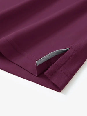 Detail view of the bordeaux red long sleeve pique polo, showcasing the hem opening and sleek fit.